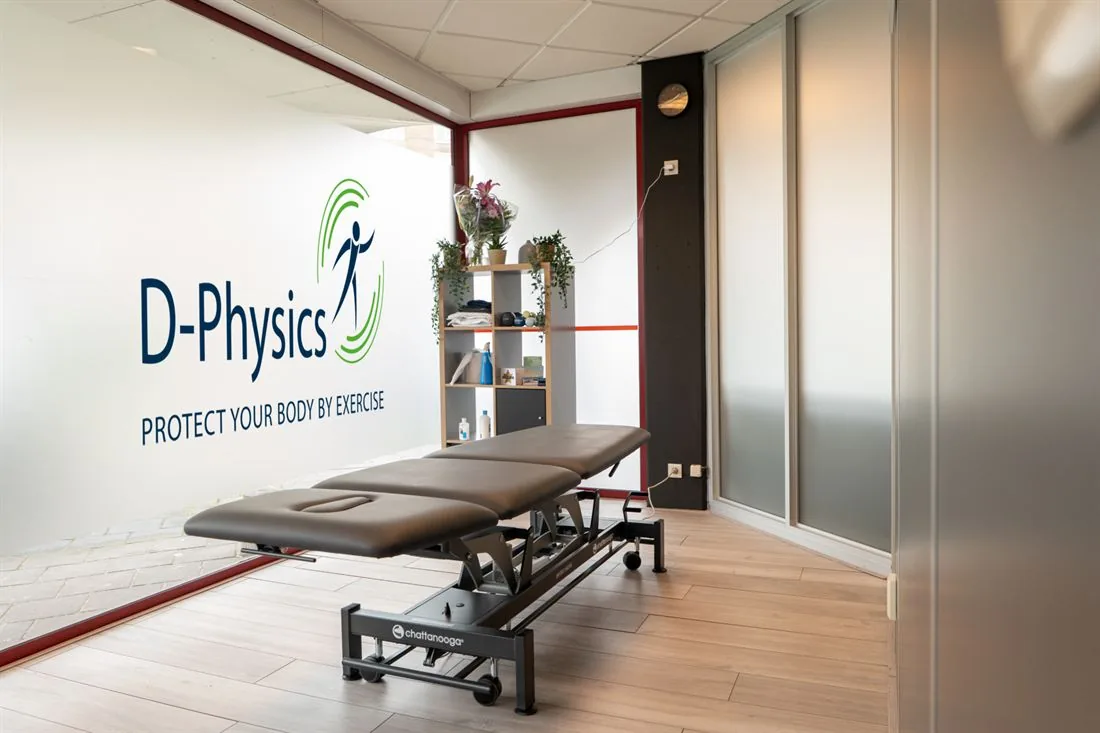 Behandelruimte van D-Physics met het logo op de muur